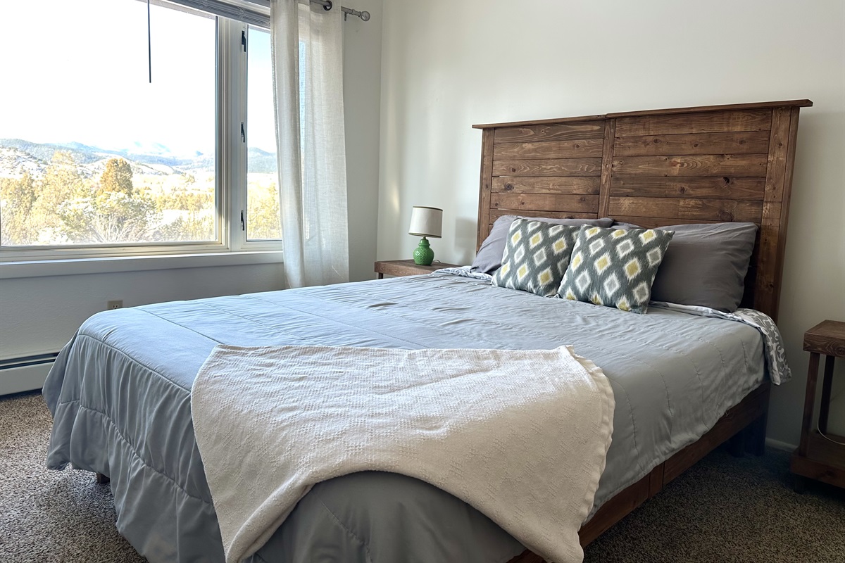 The middle queen room has lovely west-facing views of the Highland Mountains and Montana's wild wilderness. Catch amazing sunsets from bed! And then watch some DVDs. 