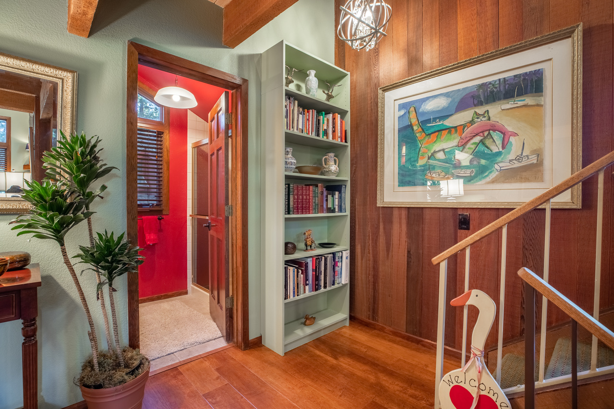 Main level landing, red bathroom, bookcase.