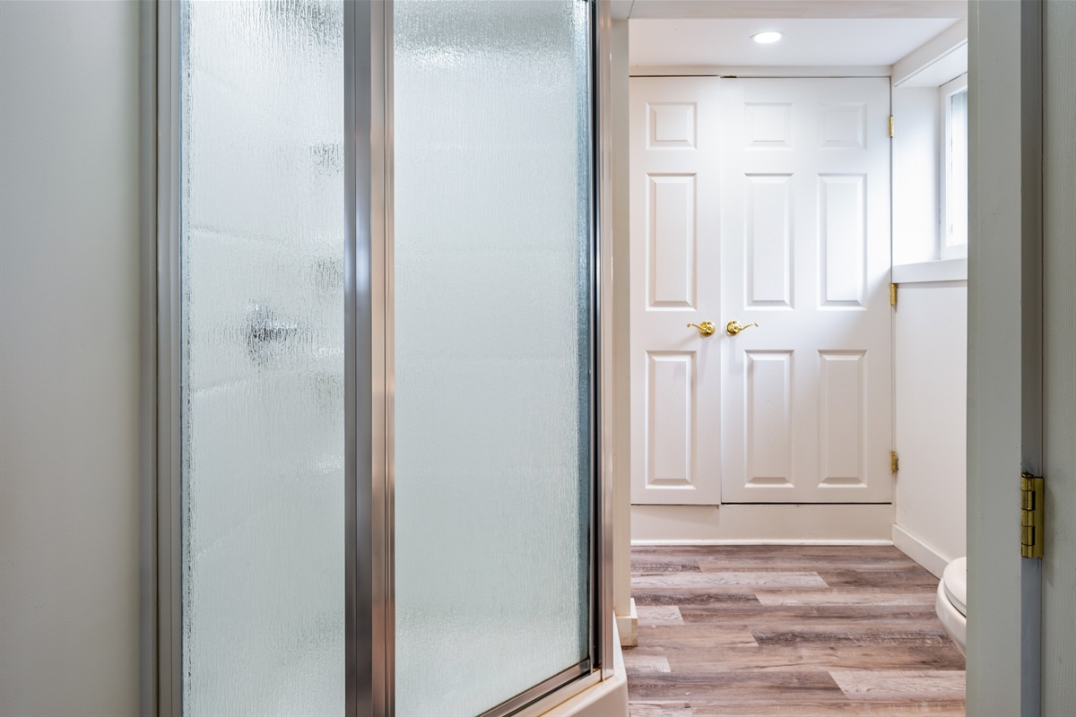 Fresh and functional full bathroom featuring a walk-in shower, modern vanity, and sleek flooring—perfect for a refreshing start to your day!