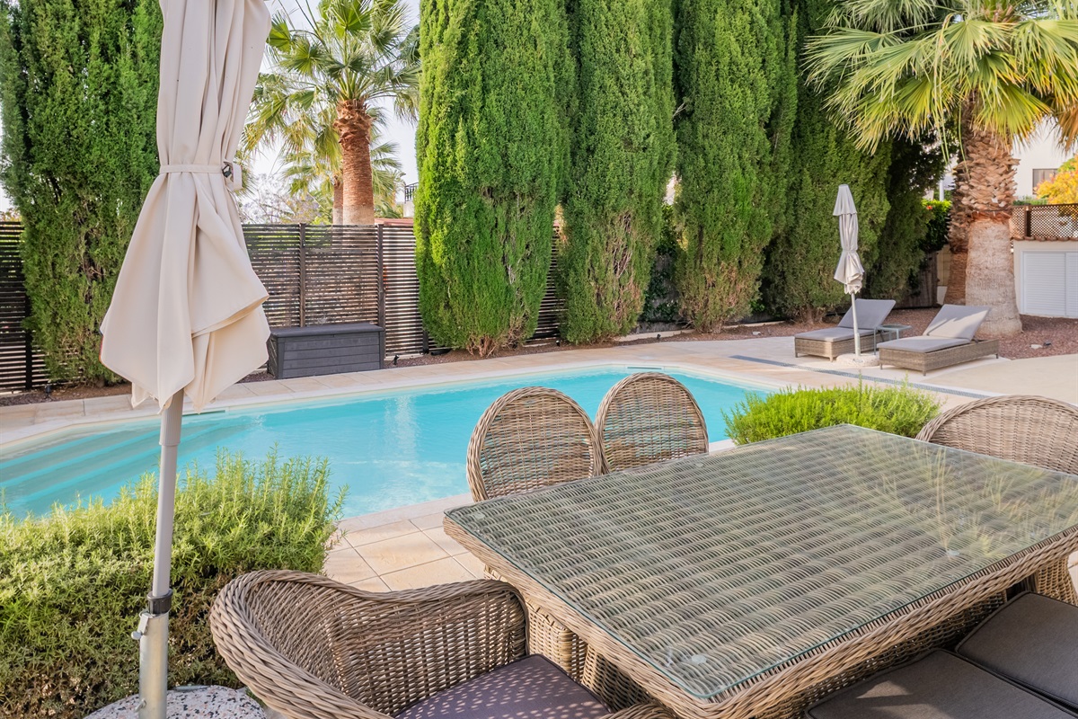 The dining patio overlooks the pool, making it easy to keep an eye on kids as they swim and play.