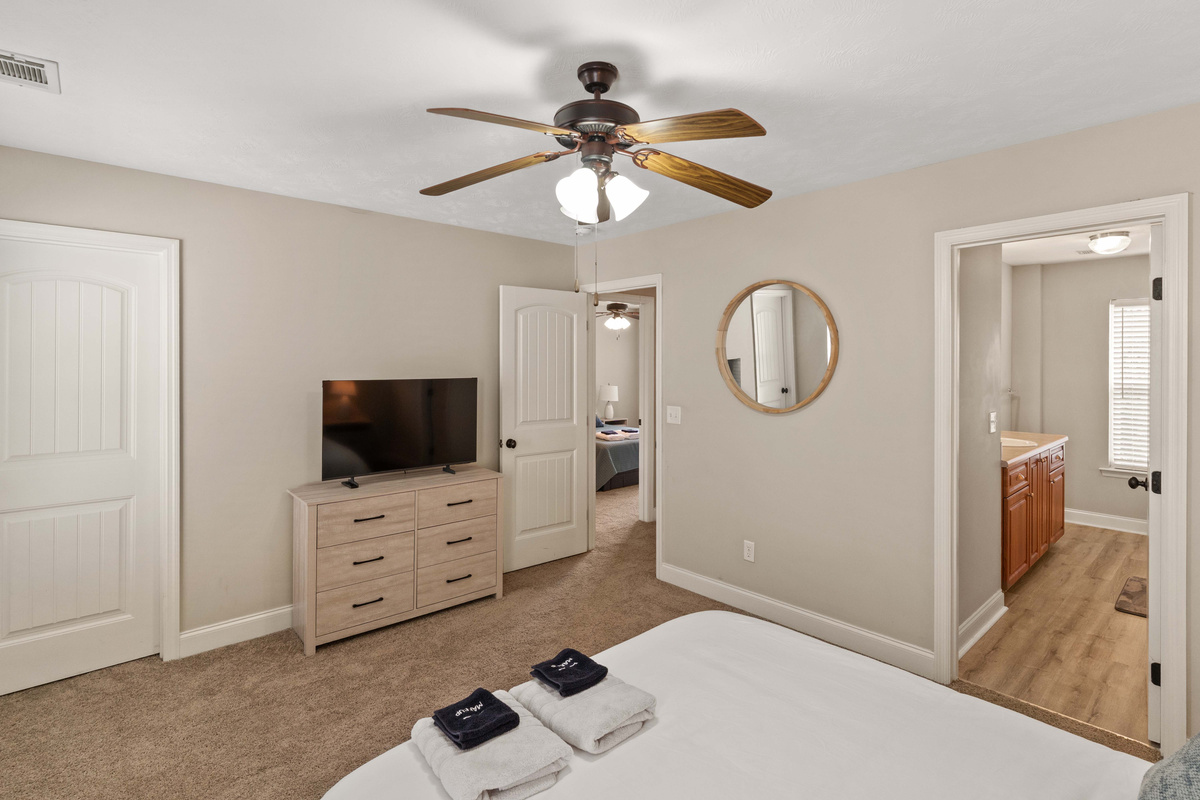 Primary Bedroom with En-suite Bathroom, Walk-in Closet, and Flat Screen Smart TV