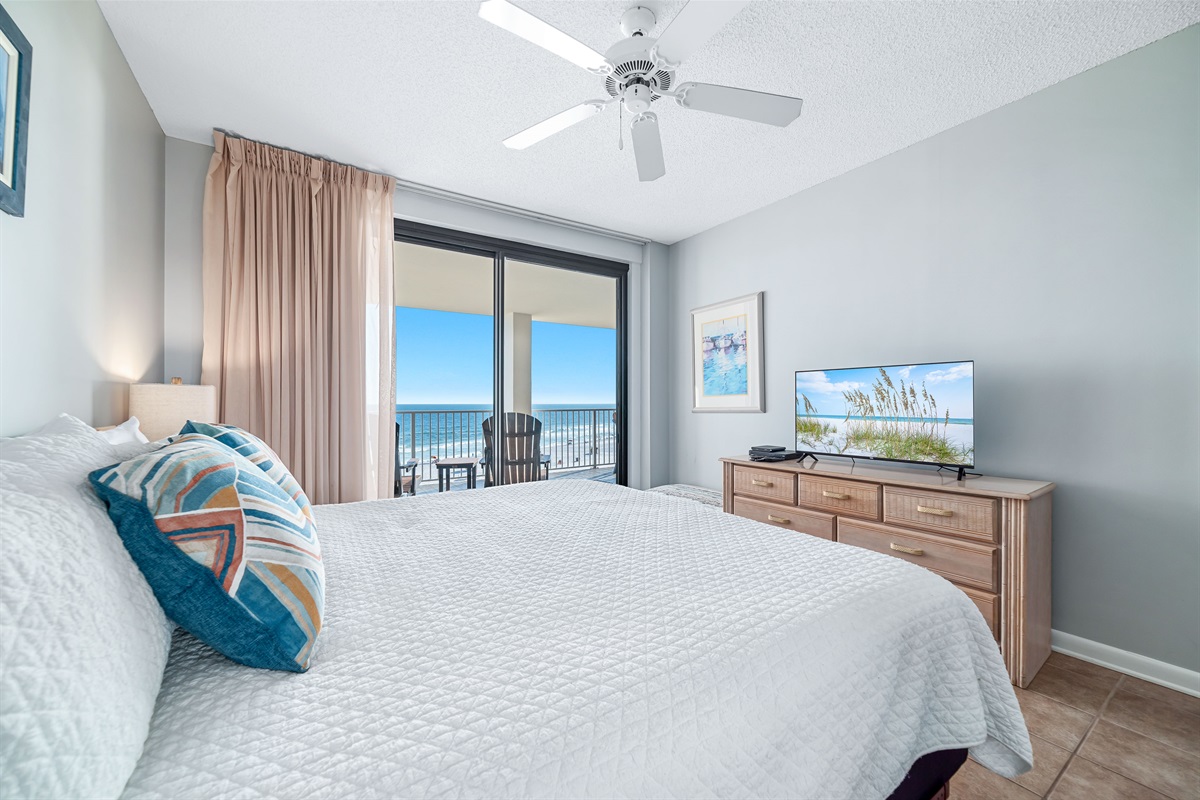 Escape to tranquility in this beautifully appointed primary bedroom, where the soothing sounds of the ocean are just beyond the balcony.