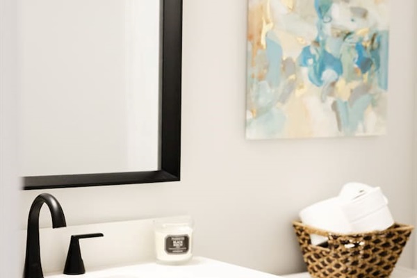 This full bathroom is located on the first floor at the hallway off the bottom of the main staircase. It includes a bathtub with shower.