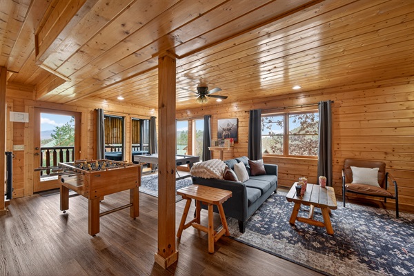 Air hockey, foosball, Smart TV, couch, board games — and the hot tub just through that door. The lower level game room is where the group ends up every night, whether anyone planned it or not.