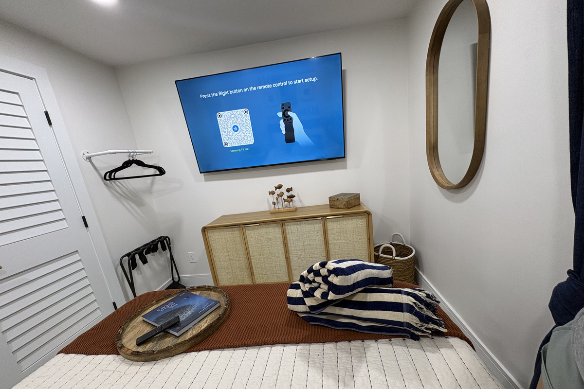 The other end of the bedroom that includes dresser, many places to store clothes & luggage.