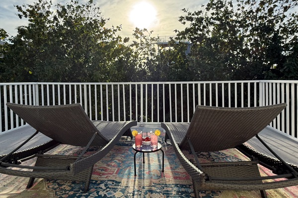 Relax off of the Primary balcony and watch as the sun fades behind the trees