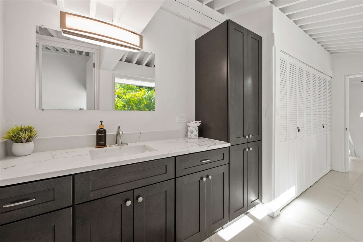 Guest ensuite bathroom with large vanity and closet space