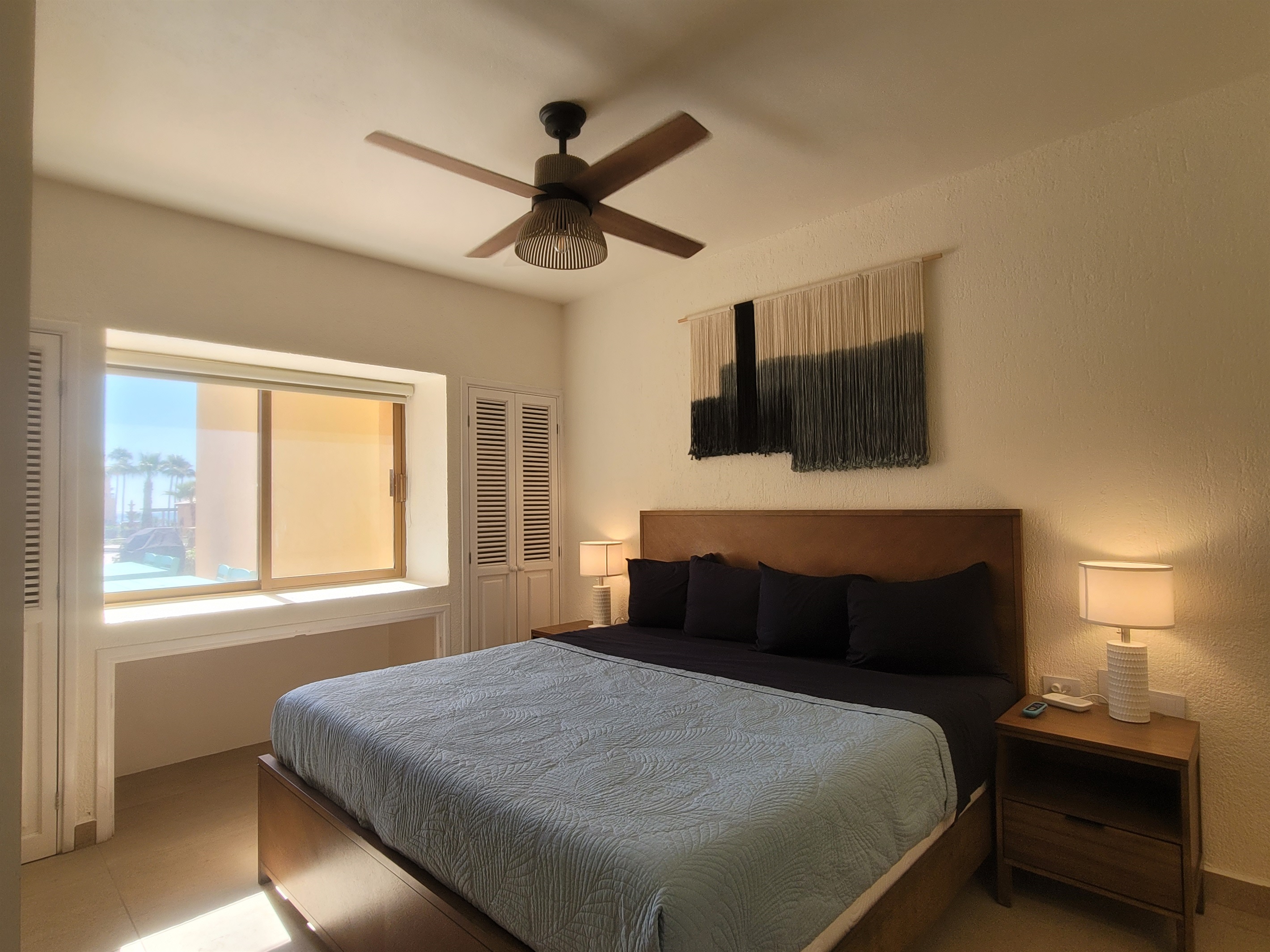 King size bed with window views of the patio and pool