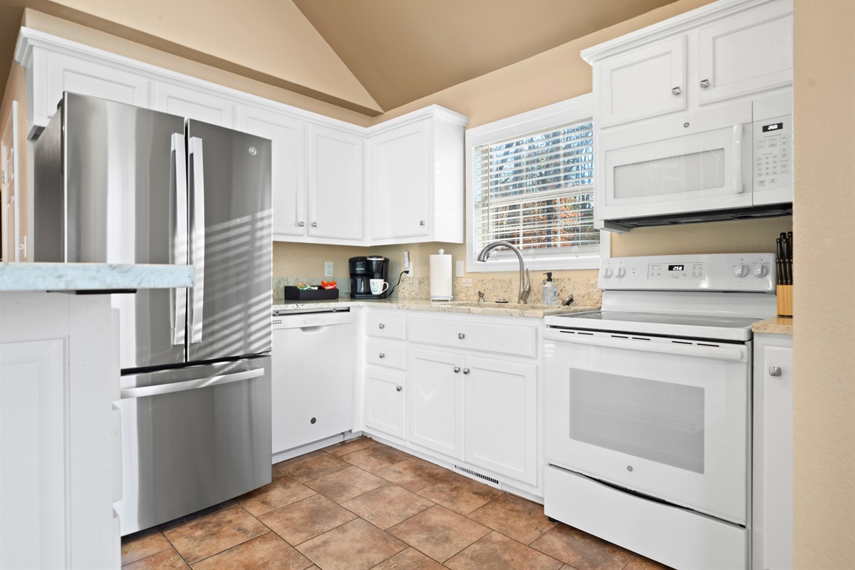 Bright cabinetry and updated appliances make it easy to prepare meals or snacks whenever hunger strikes.