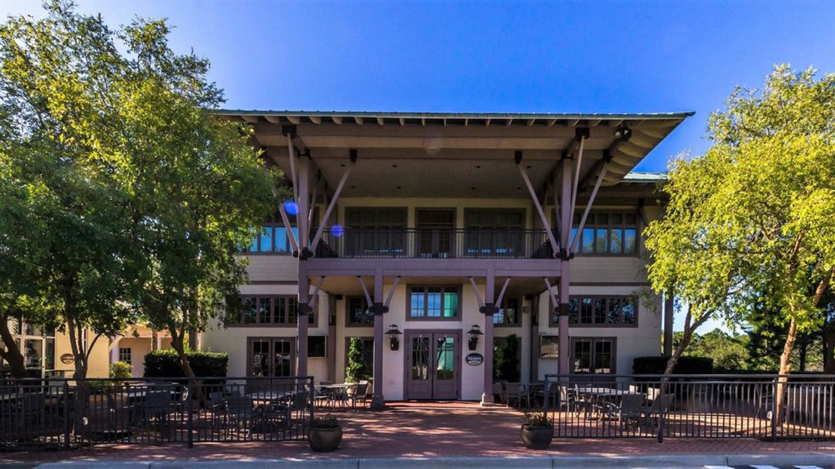 The vibrant heart of The Beach Club Resort entrance: The Village Square. Discover a delightful array of restaurants, amenities, and stores, all conveniently located to enhance your stay.