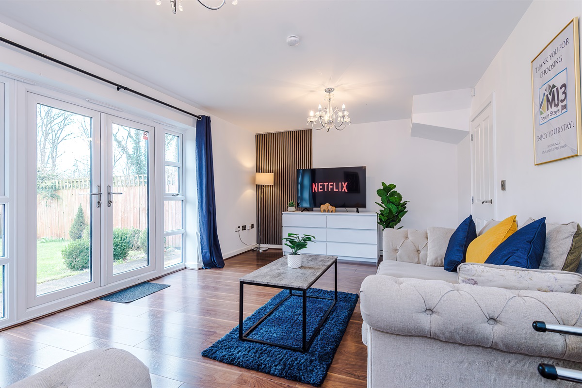 The spacious, bright and vibrant lounge benefits from a comfortable atmosphere and decor leading to the large rear garden via the French doors