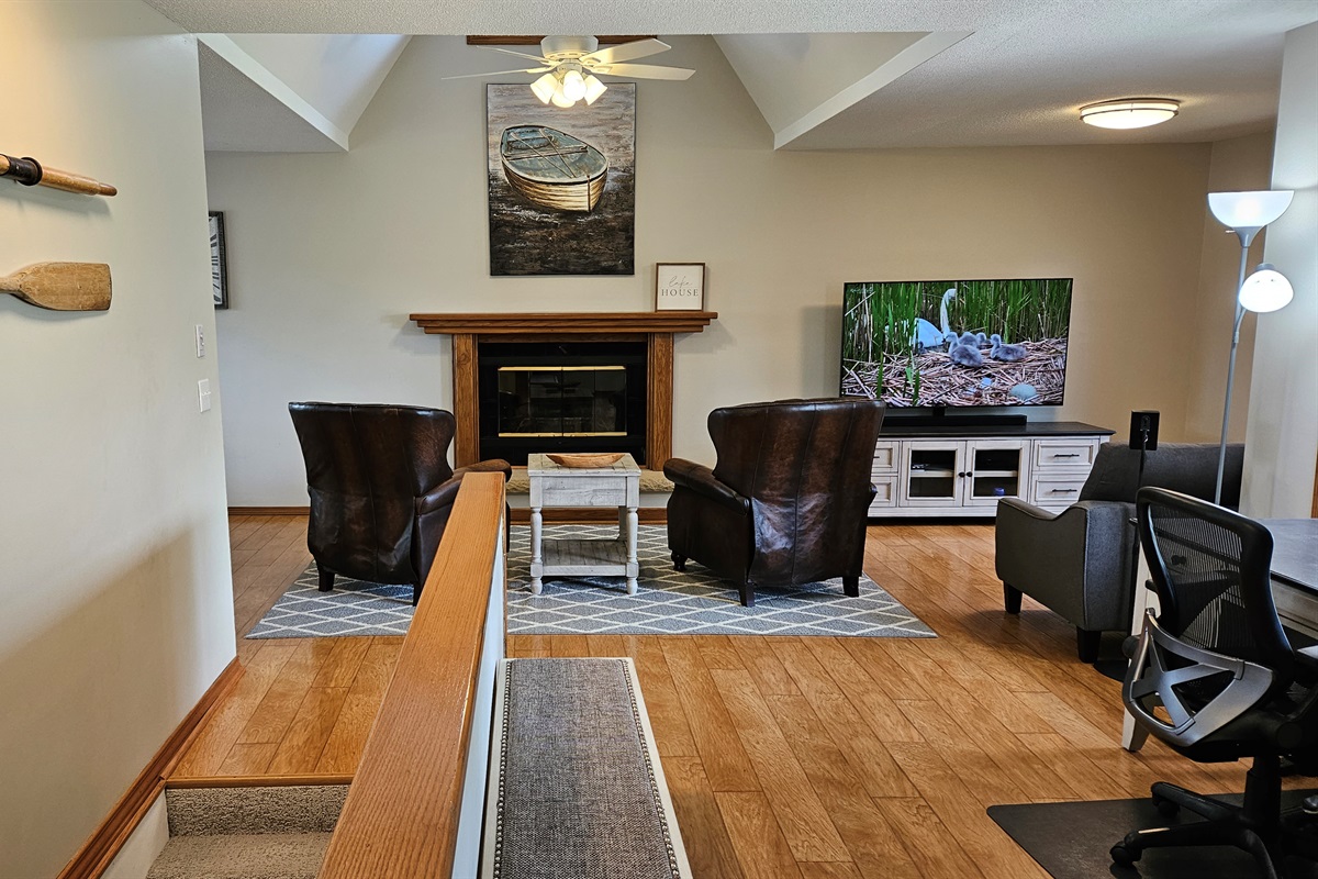 Living room features a massive flat screen TV.
