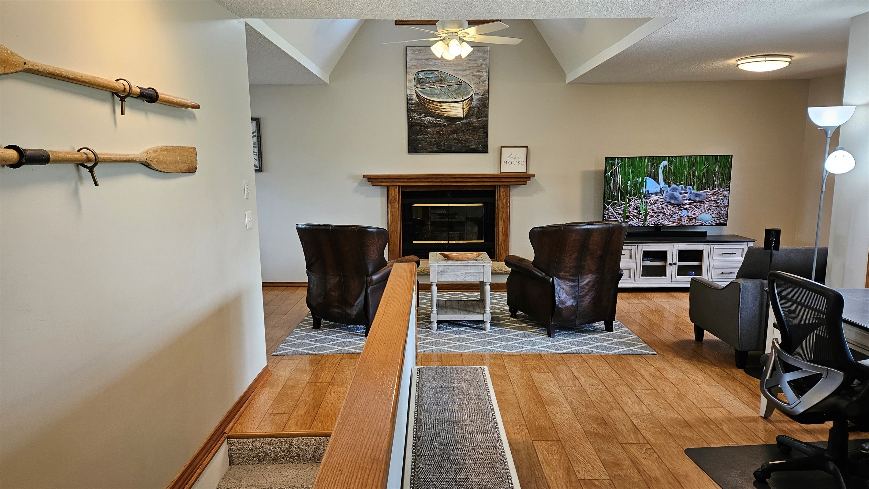 Living room features a massive flat screen TV.