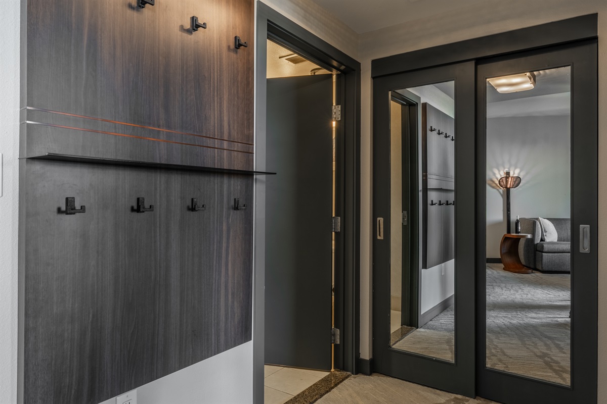 A central hallway ties the space together, creating an easy, intuitive flow between the living, dining, kitchen, and bedroom areas and providing storage for coats, gear, and luggage.