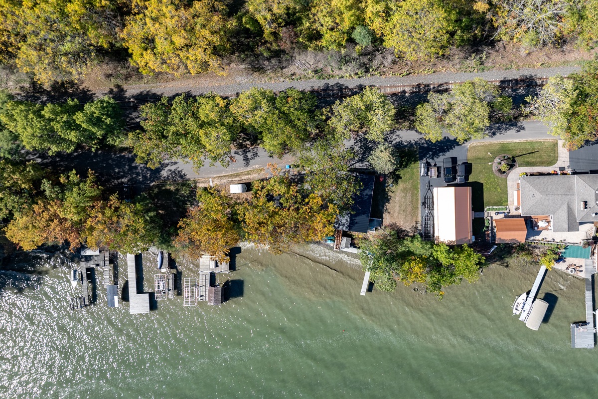 Aerial view of your serene lakeside getaway surrounded by nature and calm waters — ideal for relaxation.