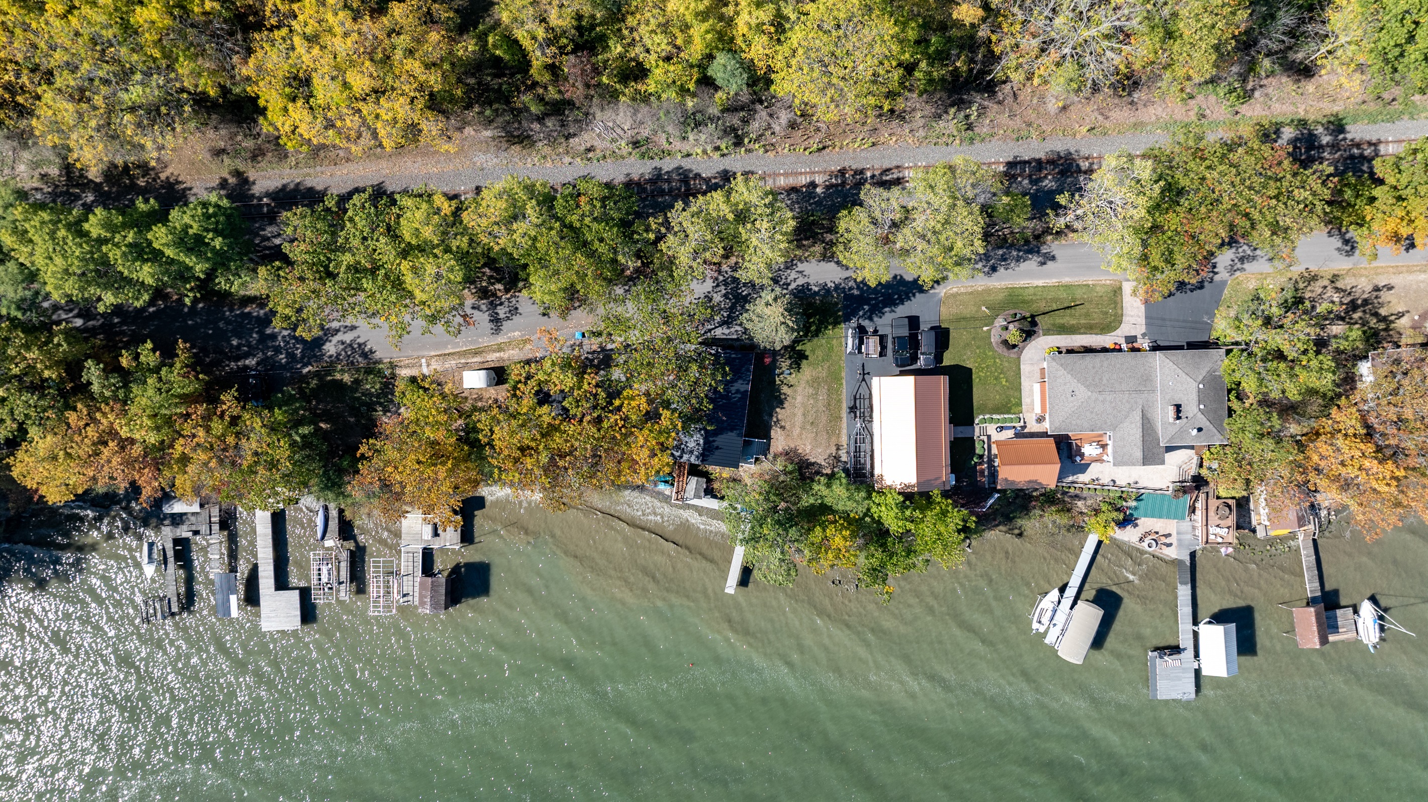 Aerial view of your serene lakeside getaway surrounded by nature and calm waters — ideal for relaxation.