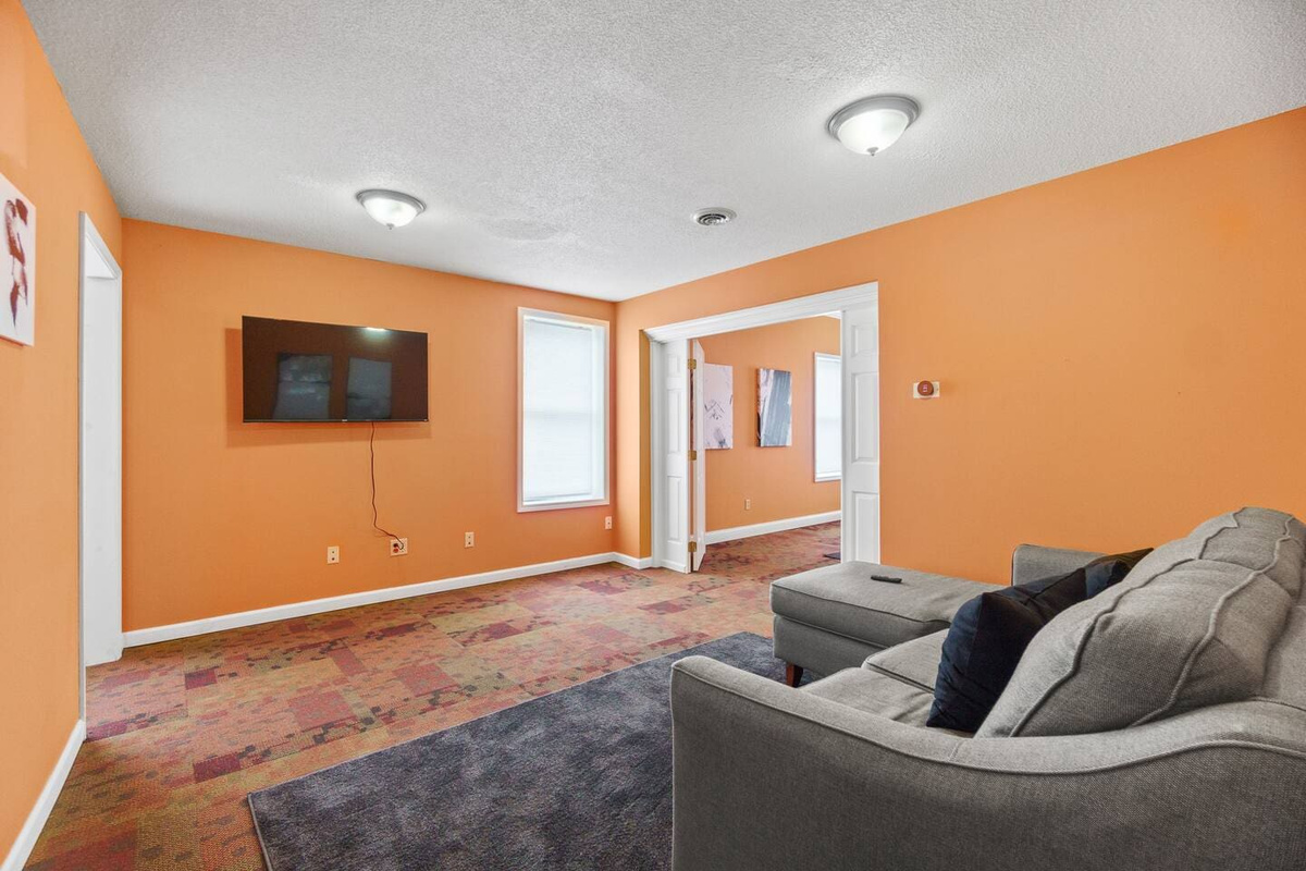 View from the couch in a spacious living area, complete with a flat-screen TV, creating a perfect spot to relax and unwind.