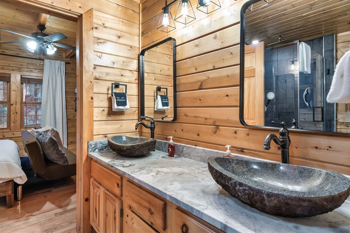 dual stone vessel sinks in the main floor master en suite bathroom