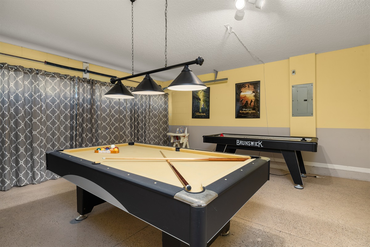 Pool table and air hockey in the game room.