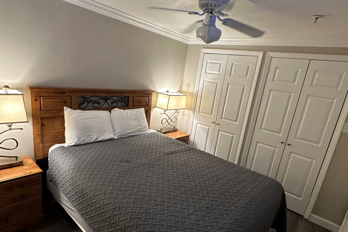 The master bedroom features a queen size bed and a large 50" television.