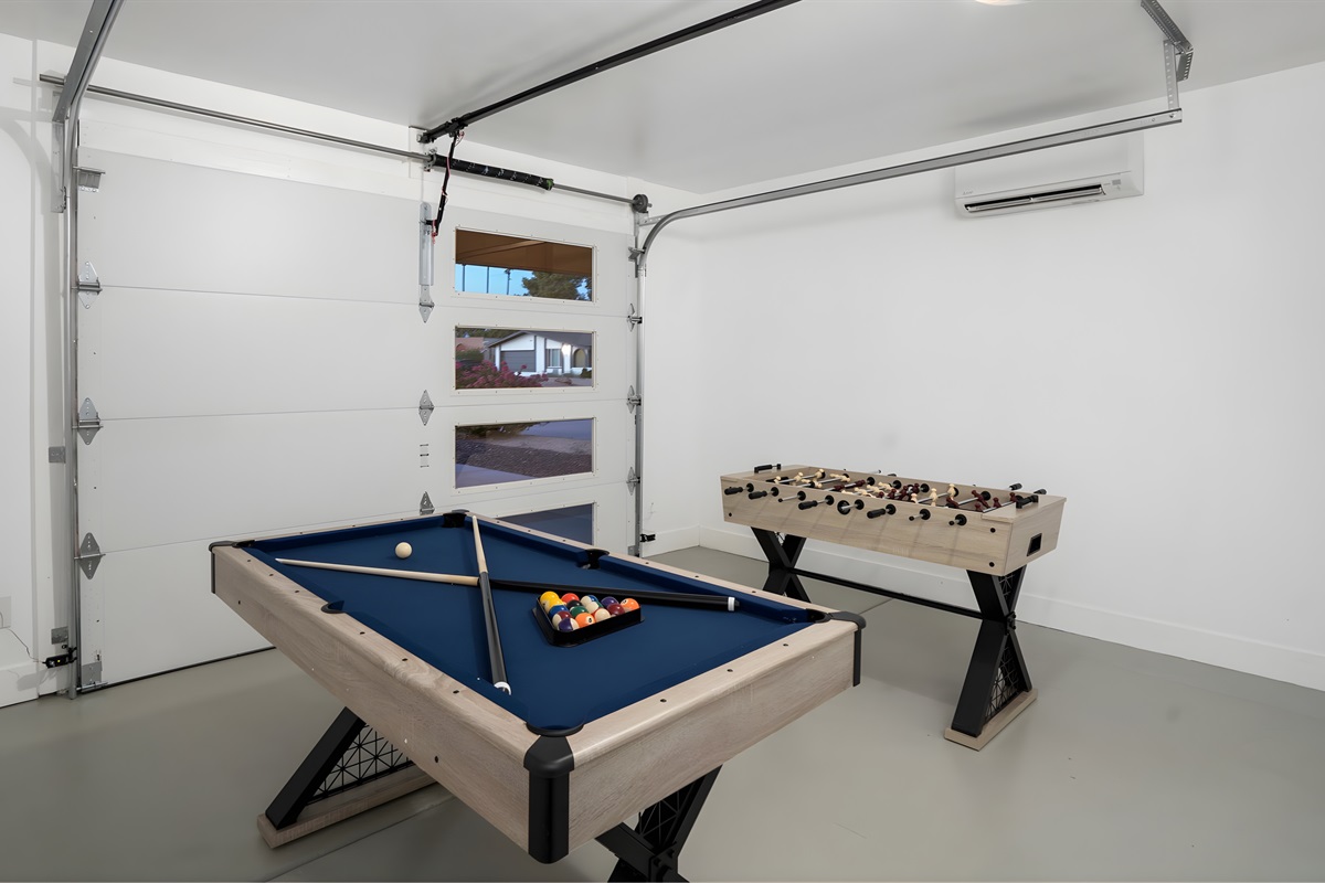 The air-conditioned garage is a fun game room with billiards, foosball & more