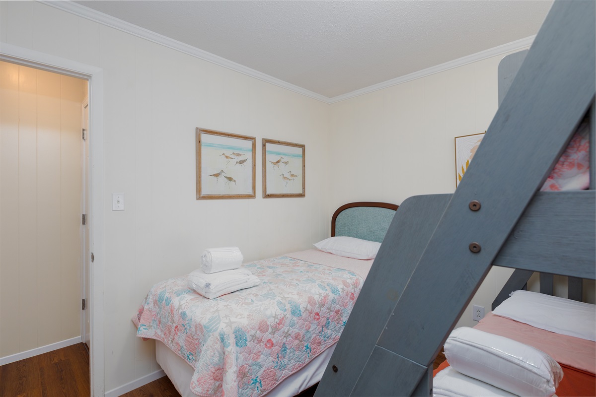 Family-friendly bedroom 4 with multiple beds for flexible sleeping arrangements