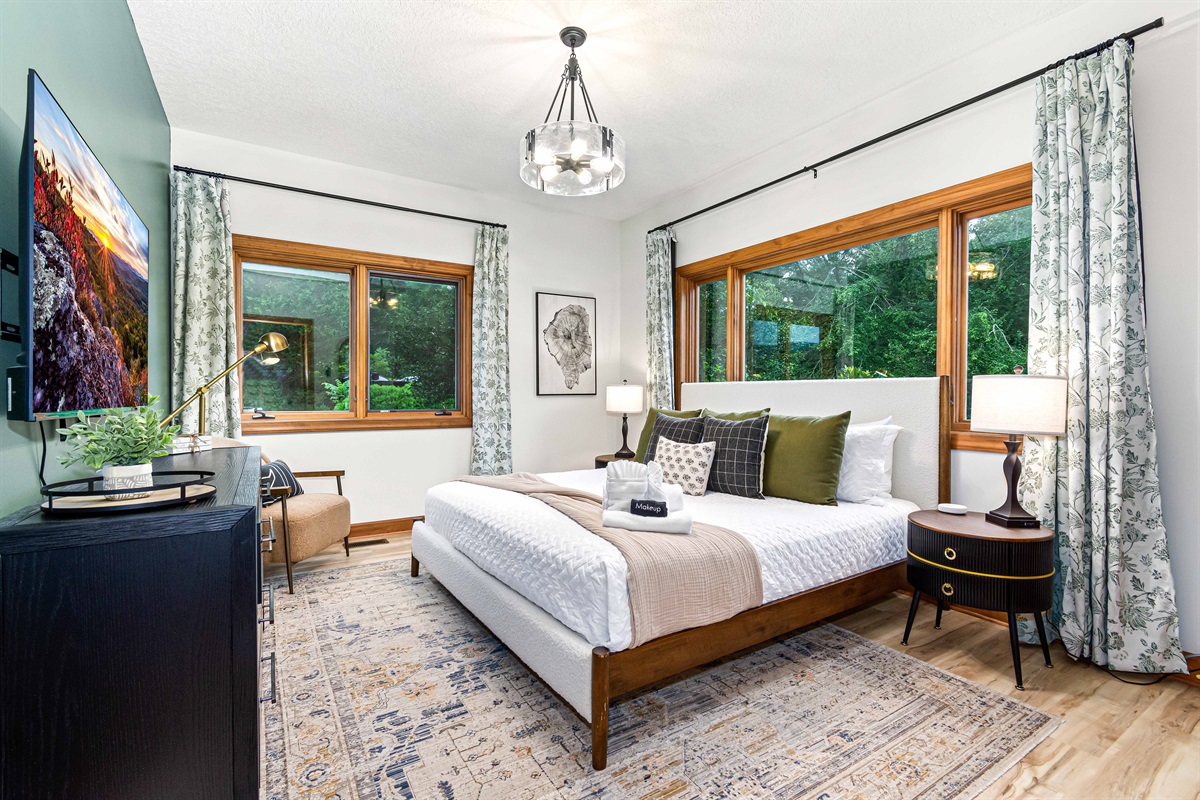 This is the third bedroom, Laurel Falls.  A peaceful guest retreat with a king bed, lush window views, and elegant touches—perfect for unwinding after a day of mountain adventures.🌿🛏️✨