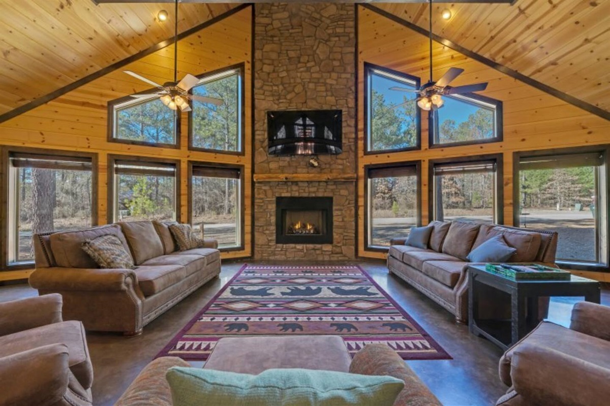 Sink into plush couches by the fireplace in this cozy Sweet Serenity living room.