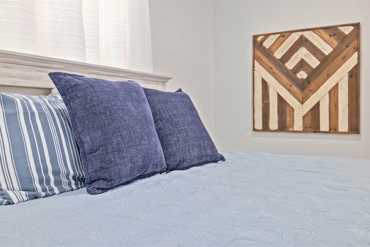 Spacious, light, and beautifully airy.
This expansive master retreat offers a ton of room to breathe, unwind, and truly relax. Soft coastal tones, a plush king bed, and abundant natural light create a calm, open atmosphere designed for effortless comfort.