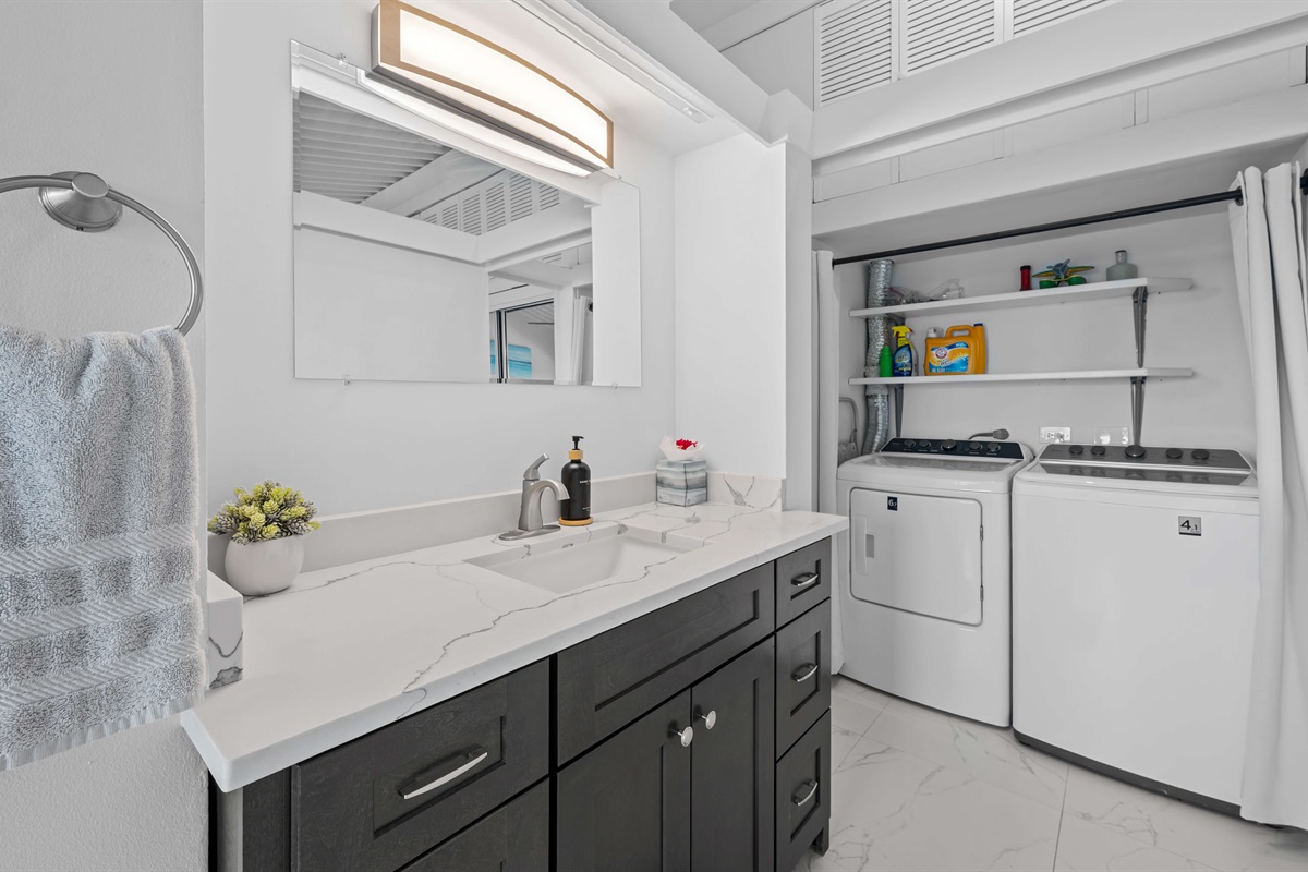 Ensuite bathroom of the primary also has the washer and dryer