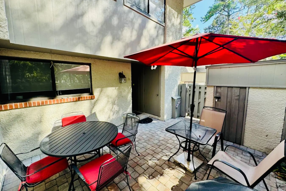 Private patio with umbrella and seating