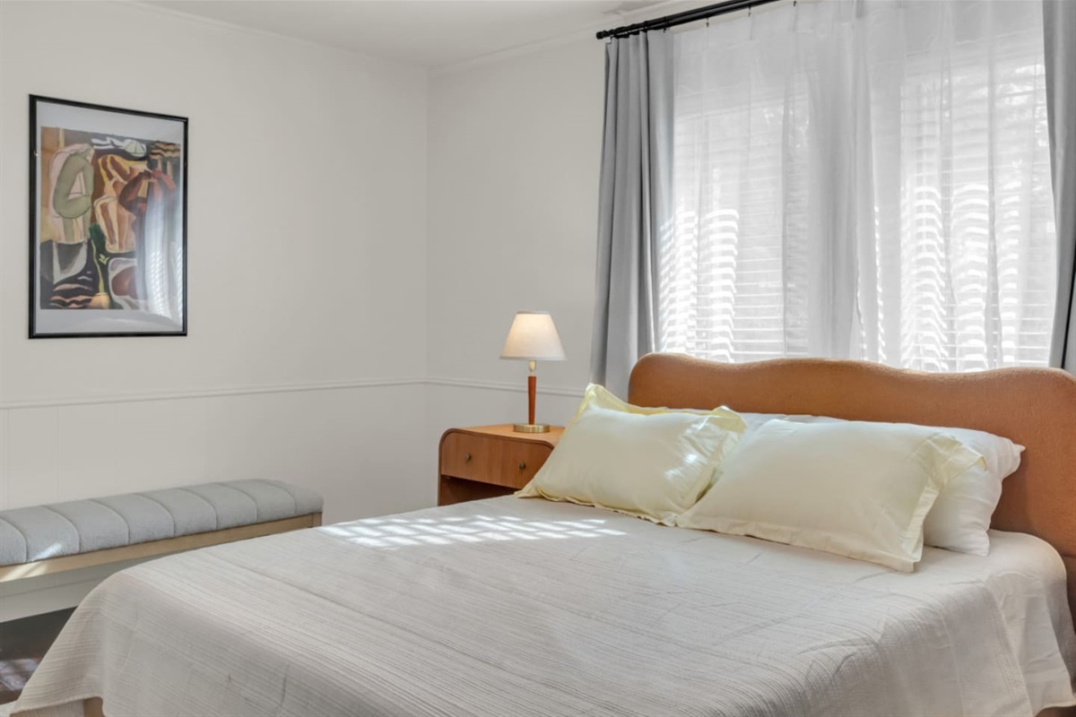 Comfortable guest bedroom featuring a queen bed designed for a restful night’s sleep.
