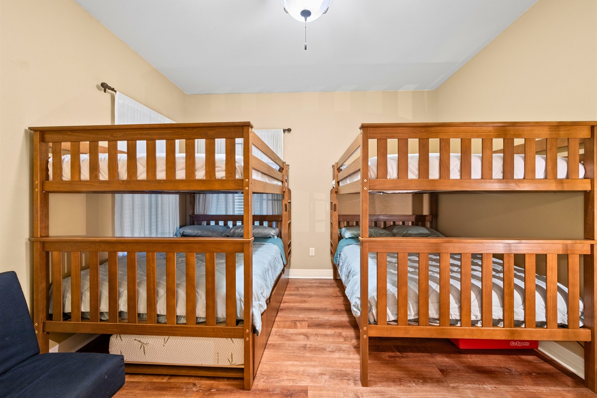 Double bunk room with cozy layout and seating.