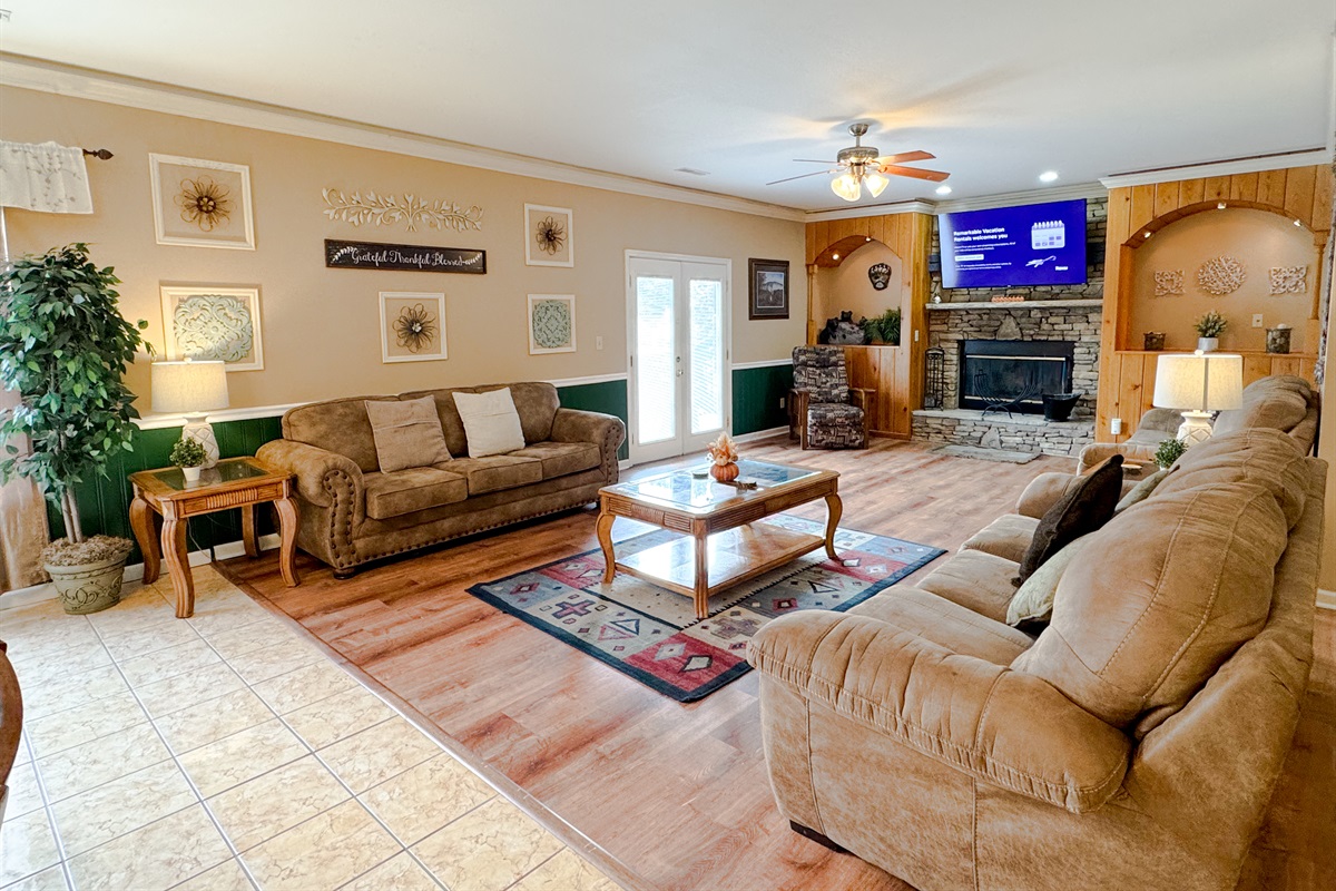 Gather the family around the fireplace or watch a movie. Right outside those French doors is a large deck with even more seating!