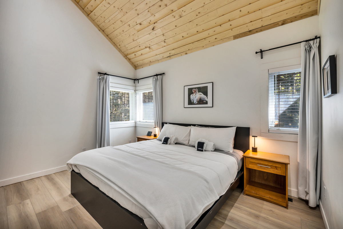 Retreat to the primary bedroom and stretch out in the comfortable KING bed beneath the warm vaulted wood ceiling.