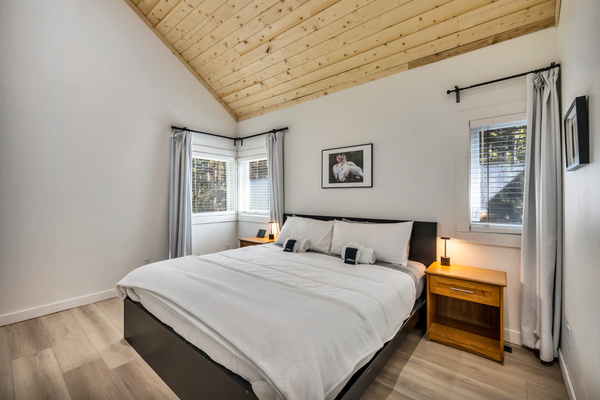 Retreat to the primary bedroom and stretch out in the comfortable KING bed beneath the warm vaulted wood ceiling.