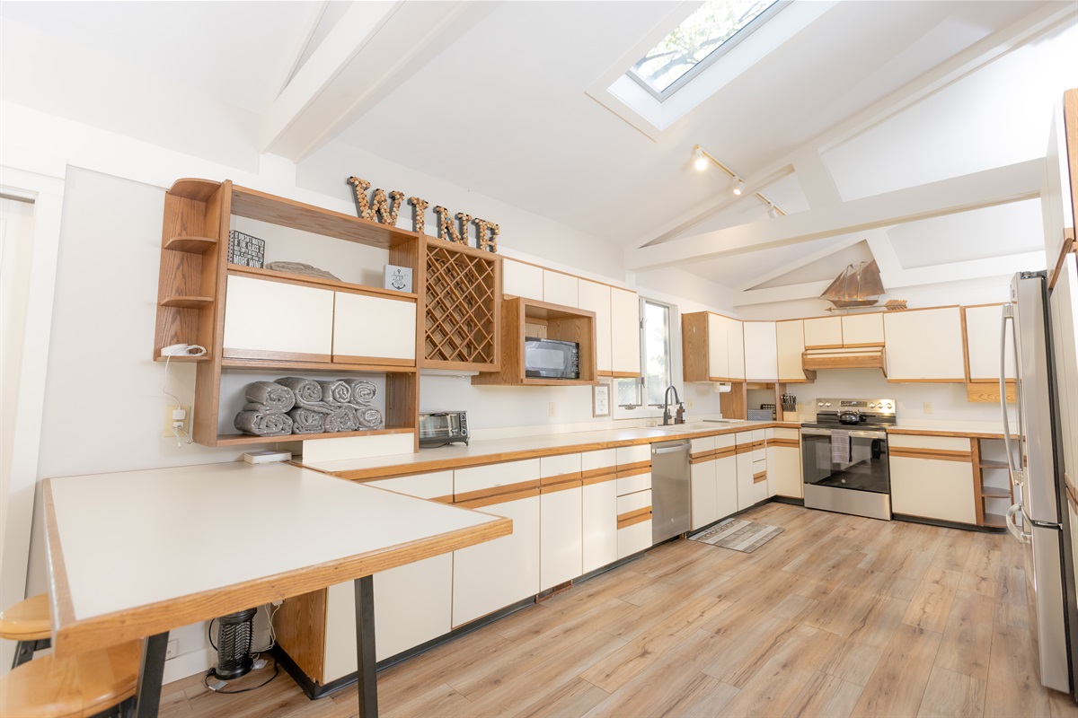 Spacious open-concept kitchen.  Cookware, flatware, dishes, and small appliances provided.