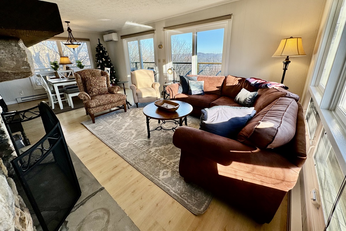 This main floor Living Room has amazing views, a comfortable sectional sofa, a wingback chair & a reclining chair in front of the gas log fireplace. Need more seating? Pull over an upholstered dining chair, or send half of them to the game room to play! ;)