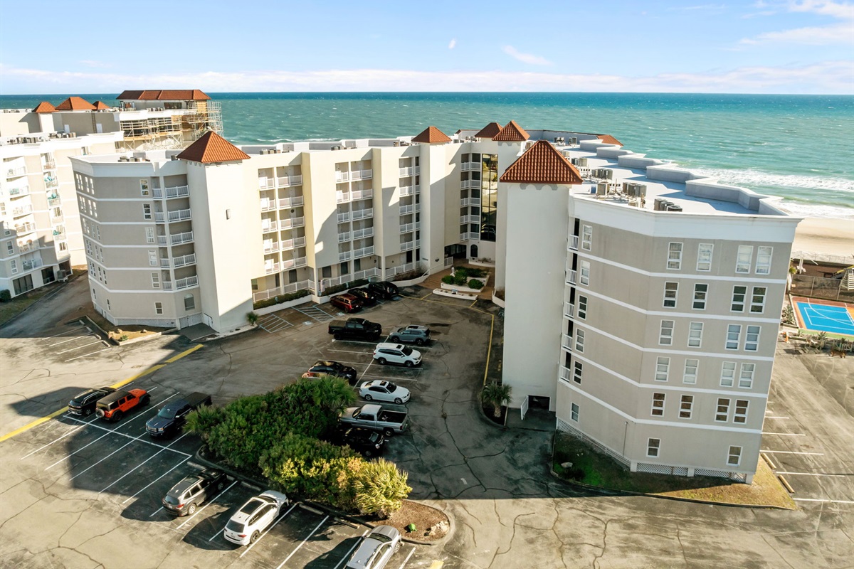 Aerial oceanfront view of St. Regis, highlighting its prime beachfront location, private balconies, and easy access to the shoreline
