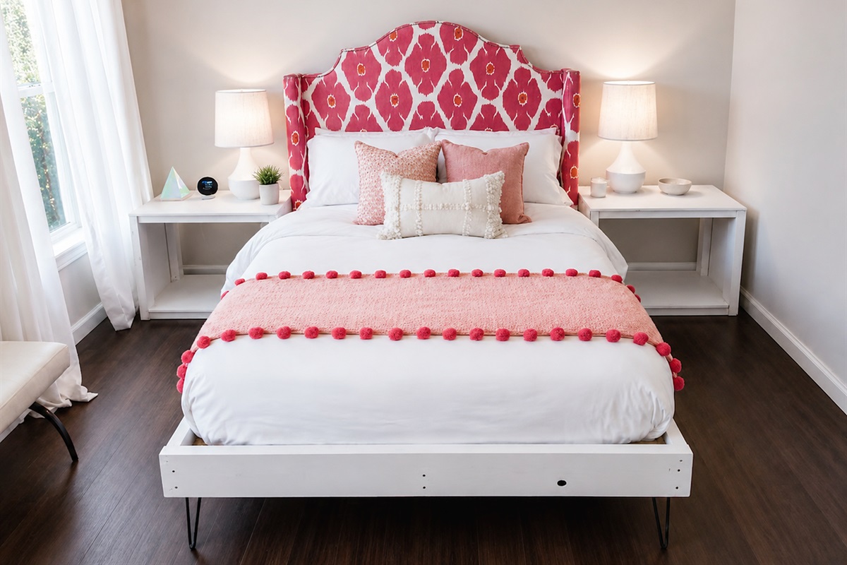 Stylish guest bedroom with bold designer headboard, cozy bedding, and warm ambient lighting