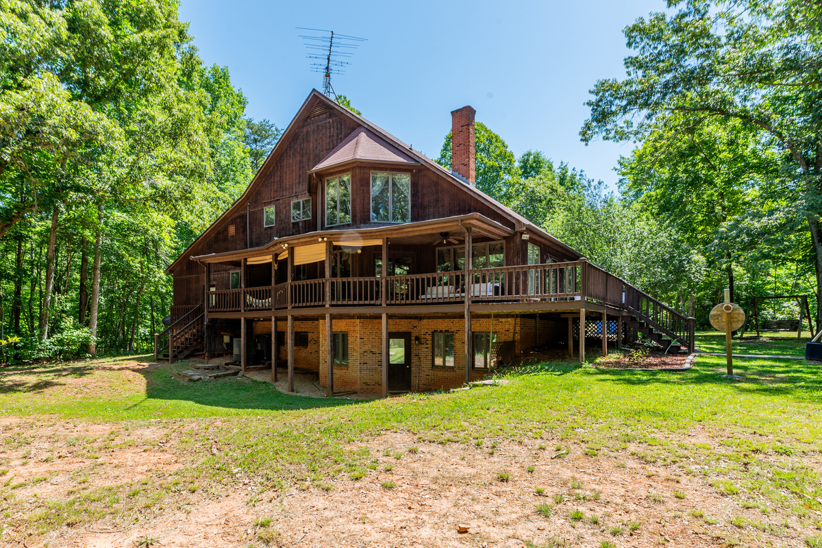 Exterior Retreat: Relax on the spacious deck surrounded by lush greenery and fresh air!
