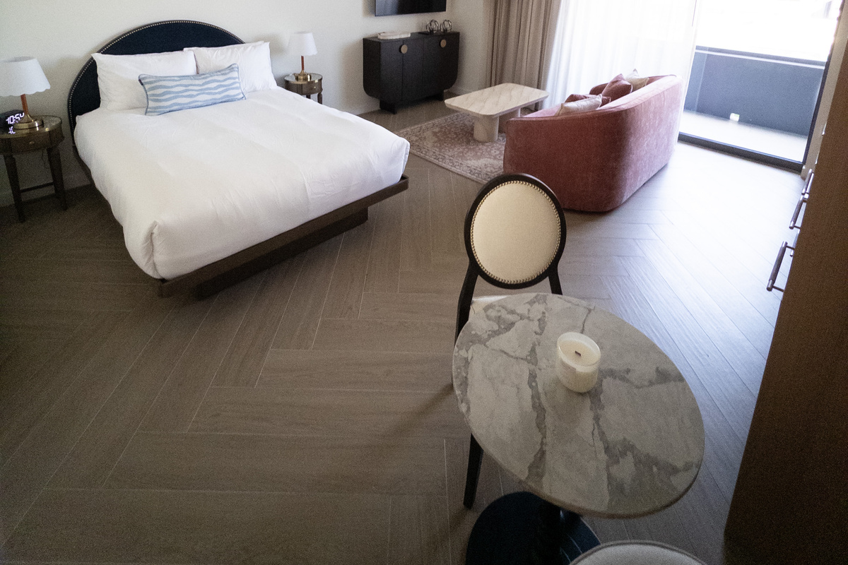 Smart studio layout - a plush bed sits steps from a built-in work nook and a sun-filled window.
