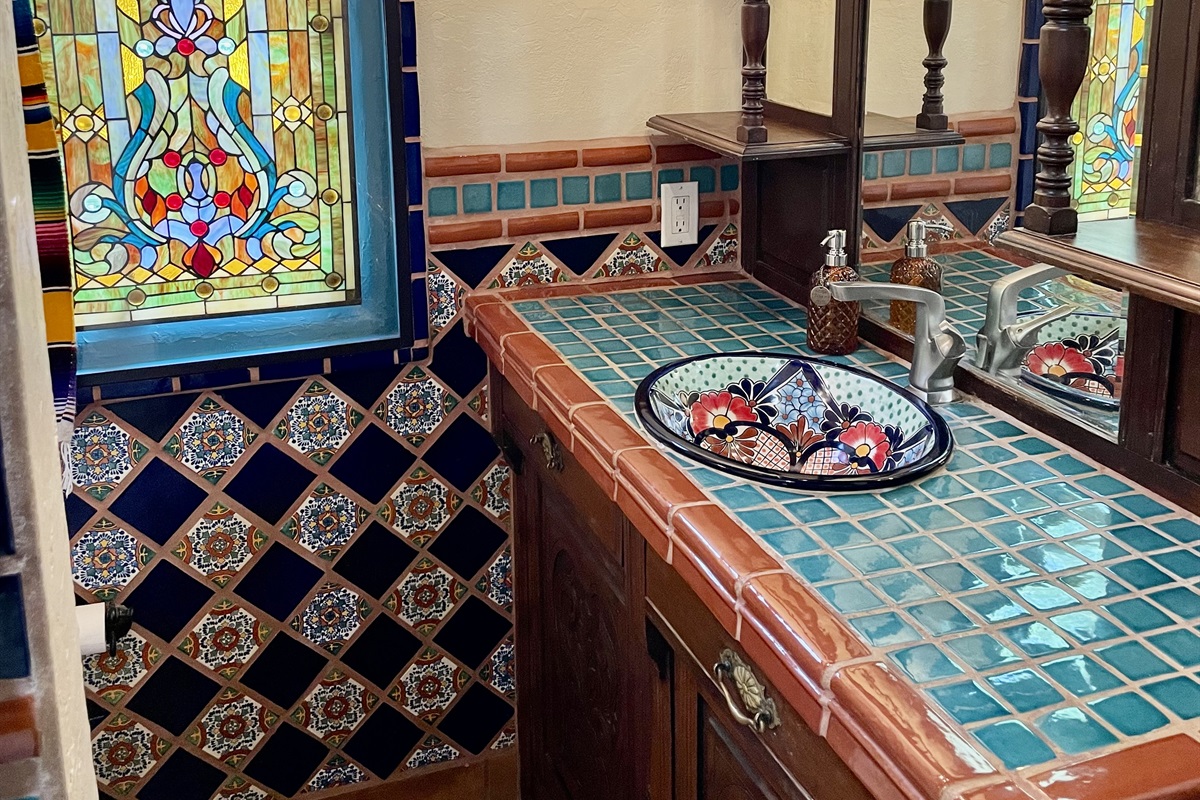 Experience the beauty of authentic tilework in this bathroom, showcasing vibrant colors and traditional patterns.