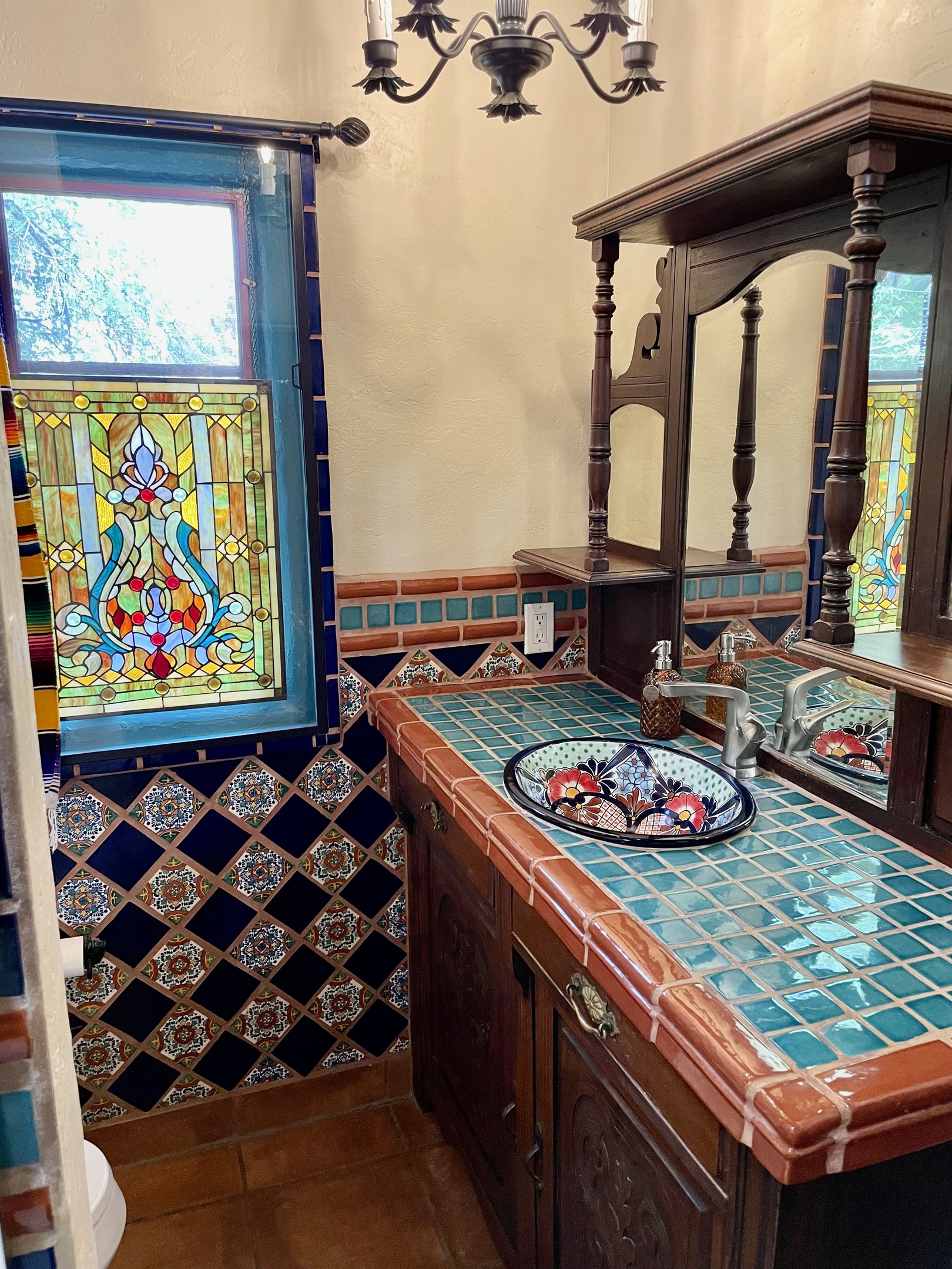 Experience the beauty of authentic tilework in this bathroom, showcasing vibrant colors and traditional patterns.