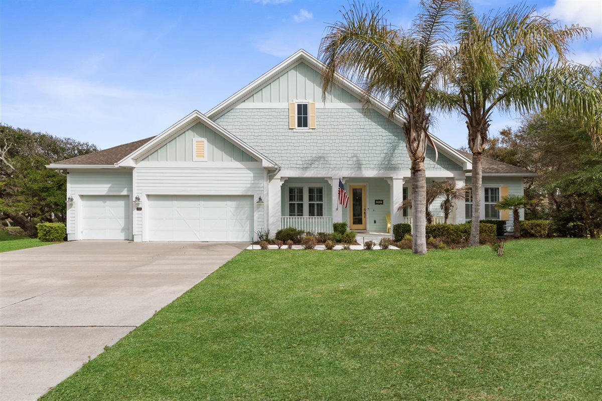 Pull into the drive, spot the palms swaying, and feel vacation settle in—this bright coastal home welcomes you with breezy charm, a sunny porch, and the promise of slow mornings, beach days, and easy nights together.