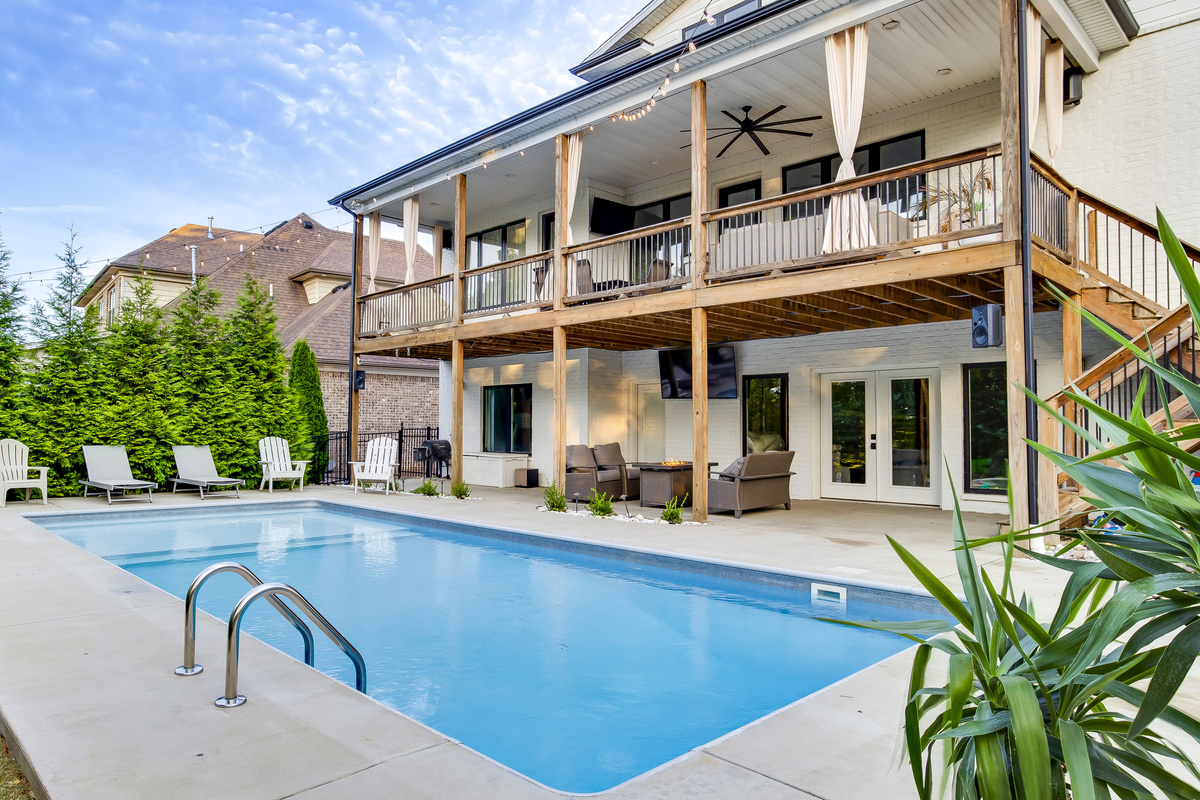Heated pool and two-level covered deck at Modern Parkside Retreat in Louisville
