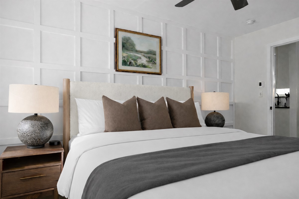 Elegant bedroom with plush king bed, soft lighting, and a stylish accent wall—offering a peaceful, hotel-like retreat for a great night’s sleep.