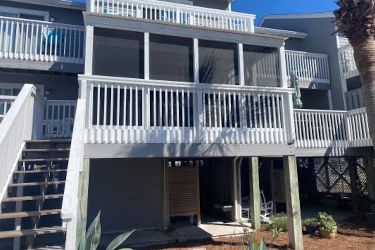 Lounge on the porch and watch the light change &mdash; the Gulf view through that screen is the best show in town.
