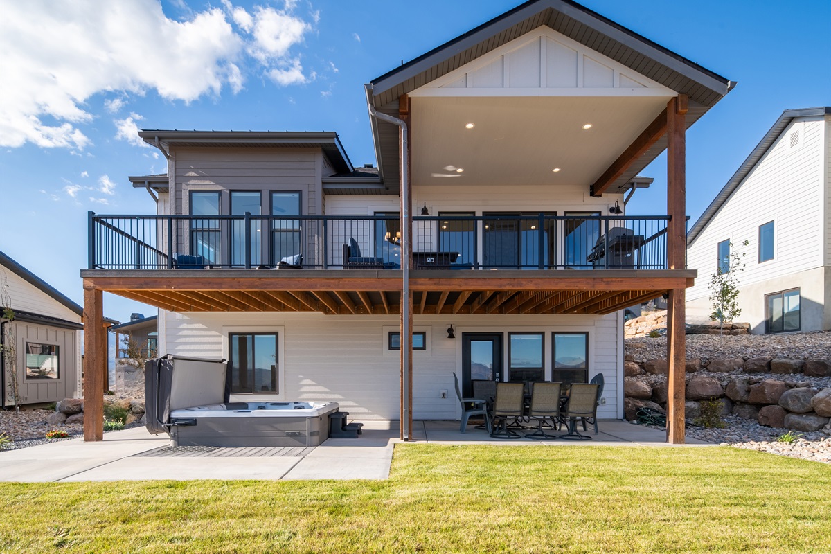 Backyard retreat with patio, hot tub, and open space to unwind.