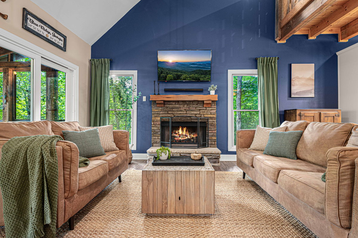 Relax in the open living room in front of the gas log fireplace while watching a movie!